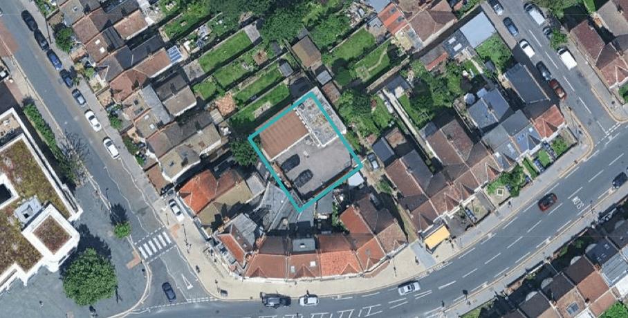 Croydon__Lower_Addiscombe_Road - SJD Projects Aerial view of a dense neighborhood; a teal square outlines the rooftop of a corner house on a curved street.