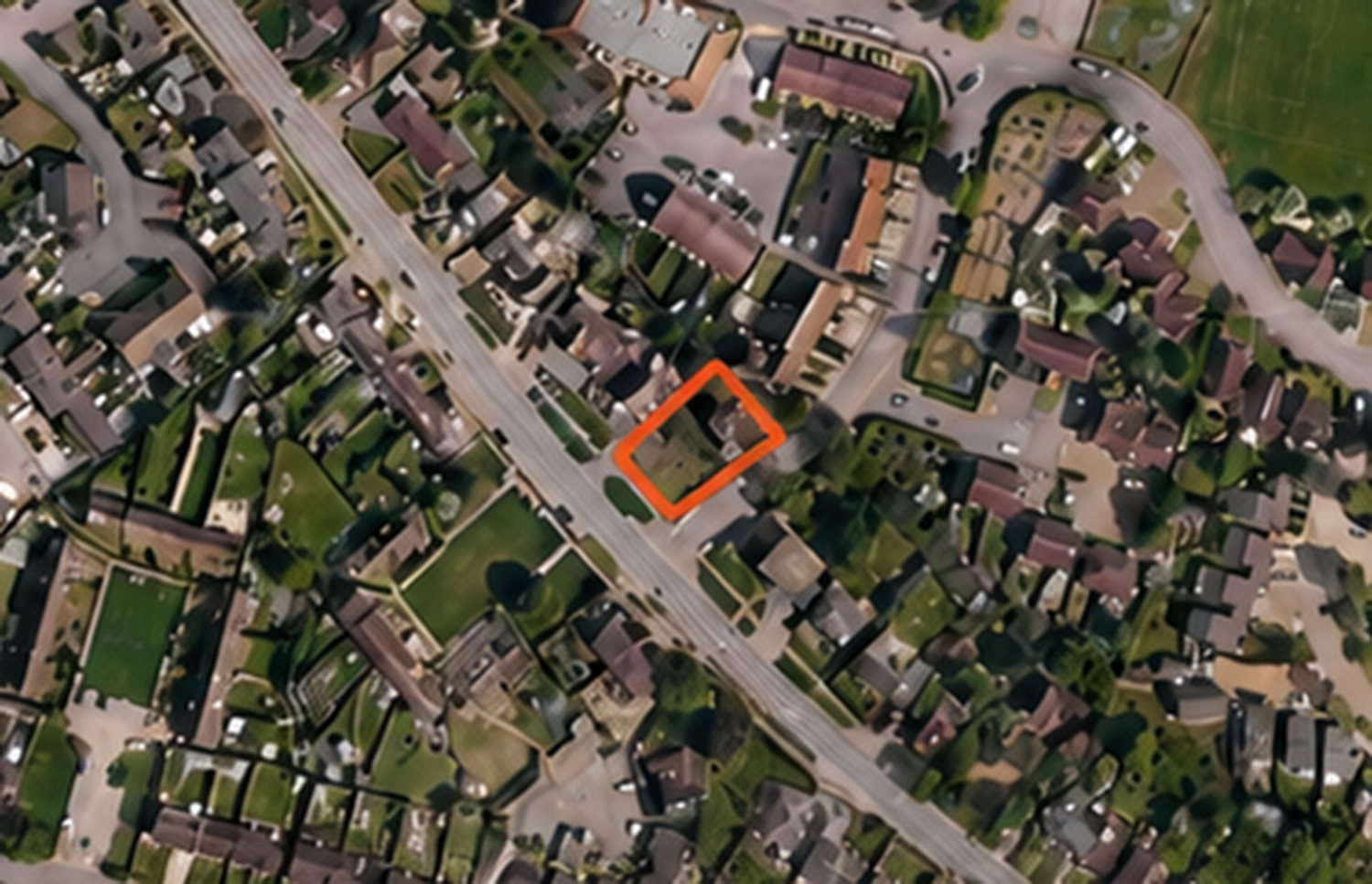 Peasmarsh__Oast_Cottage 2 - SJD Projects Aerial view of a suburban neighborhood with an orange outline around a single house lot.