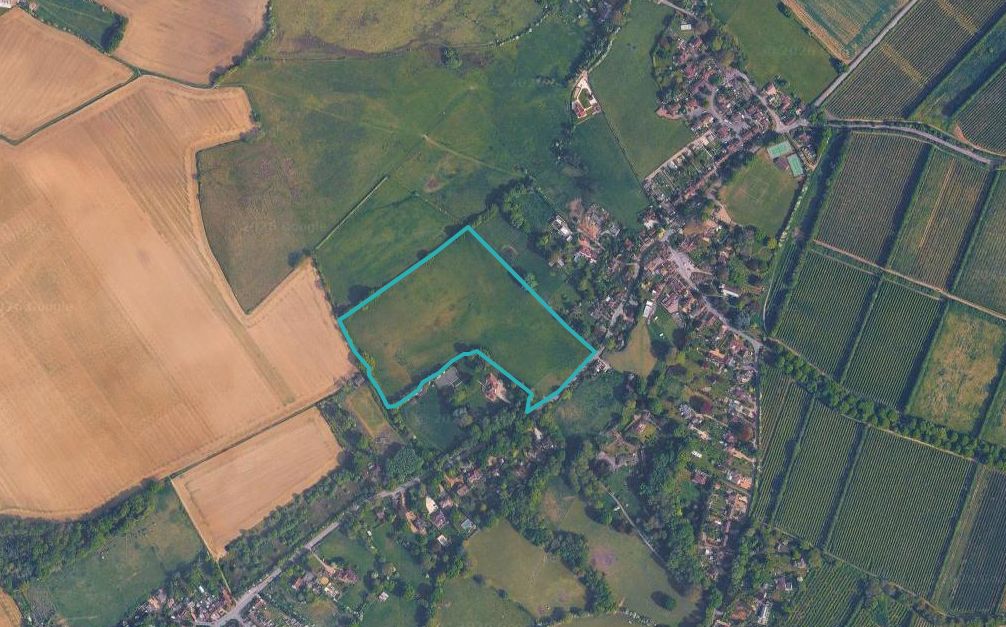 Pluckley__Forge_Hill - SJD Projects Aerial view of farmland and a small village; a turquoise-outlined irregular-shaped plot sits among fields and houses.